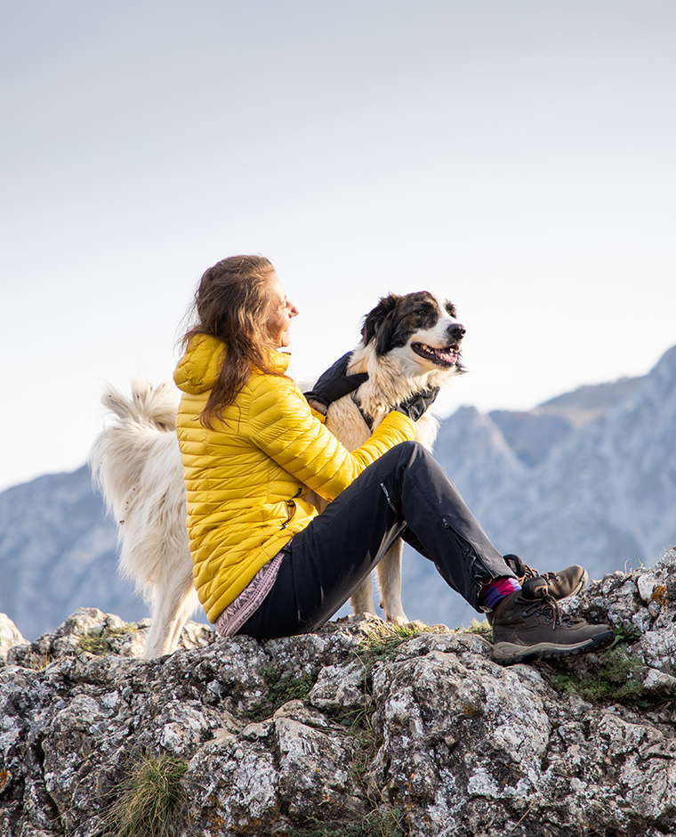 Donna in cima a una montagna con cane distanza sociale